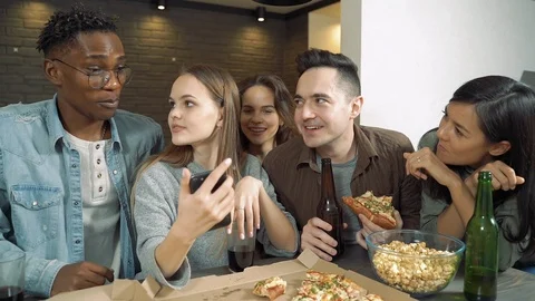 Multi-ethnic group of friends talking laughing and drinking beer at a bar Stock Footage 122744287