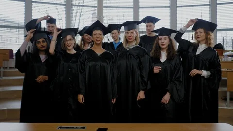 Multi ethnic group of graduated students throwing hats Stock Footage 104908988