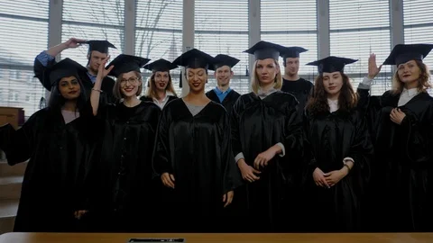 Multi ethnic group of graduated students throwing hats Stock Footage 104909028