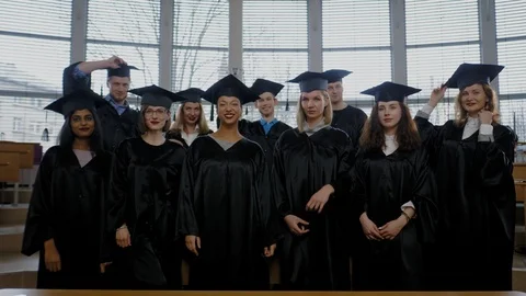 Multi ethnic group of graduated students throwing hats Stock Footage 105015601