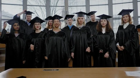 Multi ethnic group of graduated students throwing hats Stock Footage 106567061