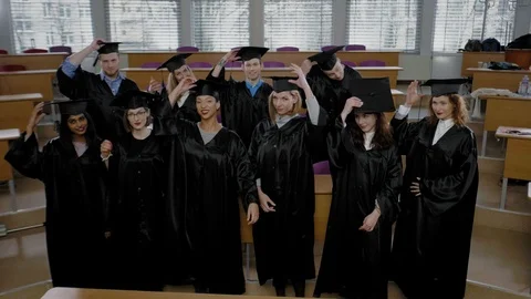 Multi ethnic group of graduated students throwing hats Stock Footage 106567089