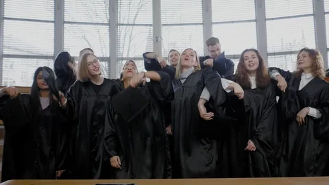 Multi ethnic group of graduated students throwing hats Stock Footage 106567102