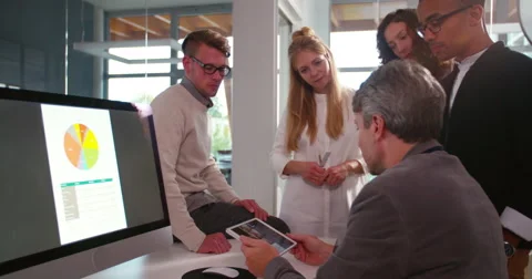 Multi-ethnic group having a quick team meeting at desk Video stock 61140840