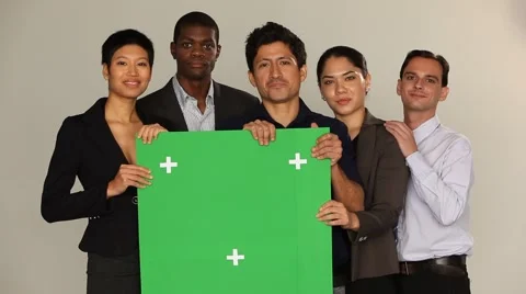 Multi ethnic group holding a green board. Smiling, casual mood. Stock Footage 40690642