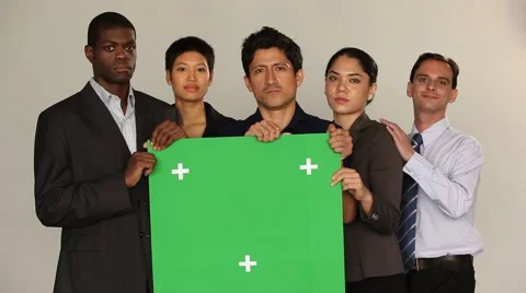 Multi ethnic group holding a green board. Serious, neutral mood. Stock Footage 40690673