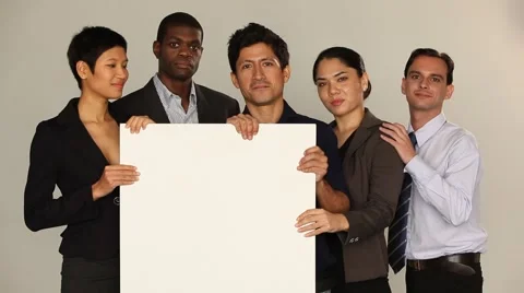 Multi ethnic group holding a white board. Smiling, casual mood. Stock Footage 40690715