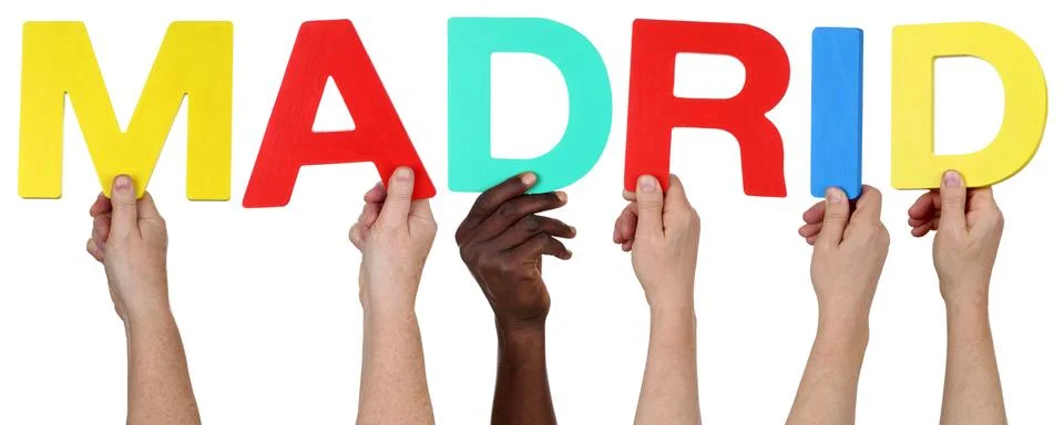 Multi ethnic group of people holding the word Madrid Stock Photos