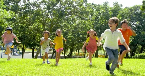 Multi-ethnic group of school children laughing and running Stock Footage