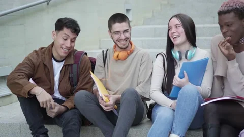 Multi-ethnic group of students, take a break sitting on the stairs Stock Footage 233074529