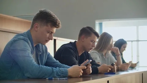Multi Ethnic Group of Students Using Smartphones During the Lecture. Young Video stock 116184917