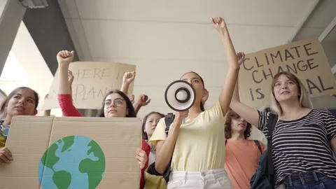 Multi-ethnic group of teenagers at a protest march, carrying signs with Stock Footage 168397130