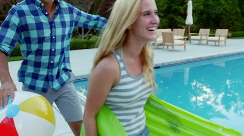 Multi-Ethnic Group Of Teens Enjoy Pool Party, They Hug, And Give Piggyback Rides Video stock 43503571
