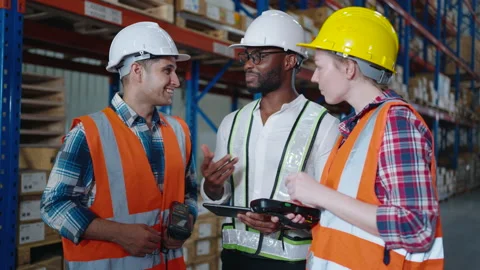 Multi ethnic group of workers have a conversation in the distribution warehouse Stock Footage 164238764