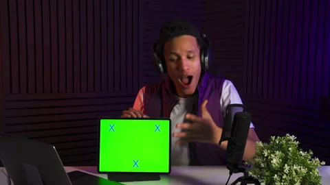 Multi-ethnic guy watch in tablet and make emotionally reaction. Green screen. Stock Footage 147100078