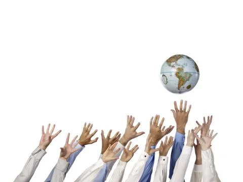 Multi ethnic hands reaching for globe ball Stock Photos