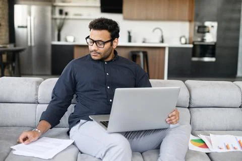 Multi-ethnic hindu freelancer guy using laptop computer for work Foto stock