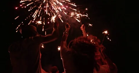 Multi-ethnic hipster friends celebrating fourth of July with fireworks display Stock Footage 80701623