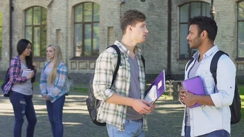 Multi-ethnic male friends joking and laughing, having break at university Stock Footage