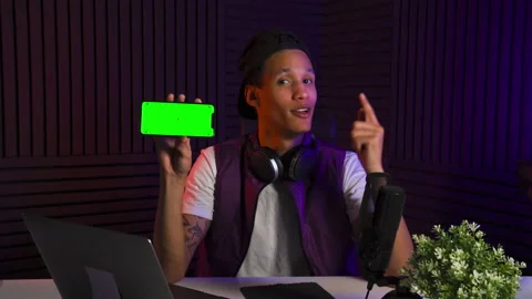 Multi-ethnic man emotionally talking about smartphone and application and smiles Stock Footage 147057261