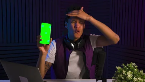 Multi-ethnic man emotionally talking abot smartphone application. Green Screen Stock Footage 147060320