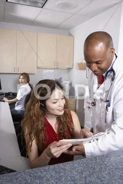Multi-ethnic medical professionals discussing chart Stock Photos