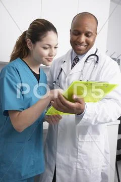 Multi-ethnic medical professionals discussing chart Stock Photos