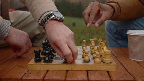 Multi-ethnic men playing chess in autumn park on a bench. Close-up. Stock Footage 271325928