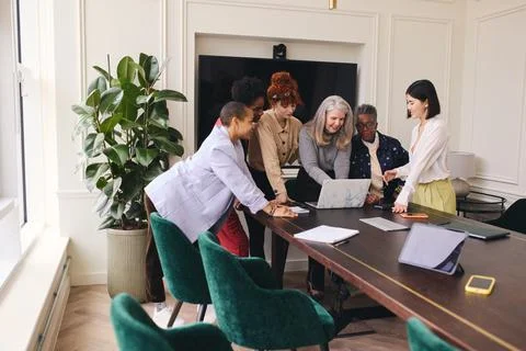 Multi ethnic mixed age range women in creative business meeting Stock Photos
