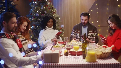 Multi-ethnic nice friends using smartphones at table connecting online Stock Footage 121593061