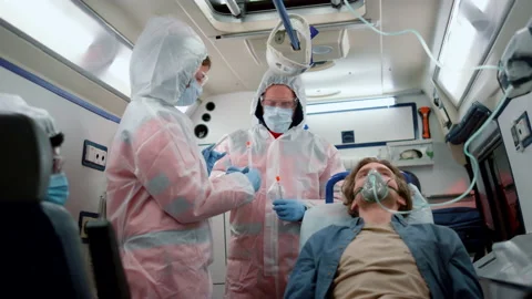 Multi ethnic paramedic team holding samples of coronavirus test in emergency car Stock Footage 166877529