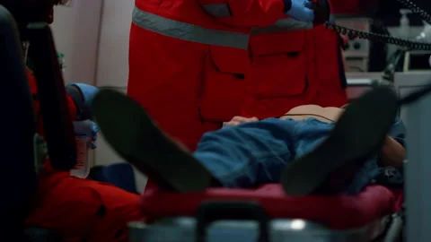Multi ethnic paramedics giving first aid help to patient in emergency car Video stock 166877426