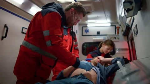 Multi ethnic paramedics performing first aid to man in emergency vehicle Video stock 166899745