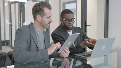 Multi Ethnic People Discussing Work on Laptop nad Digital Tablet Stock Photos