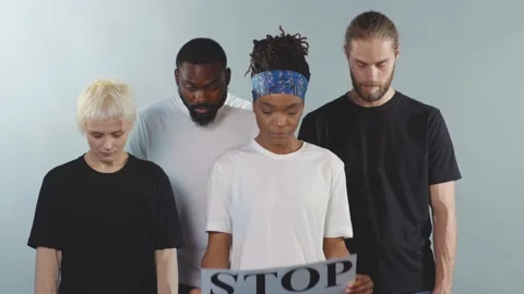 Multi-ethnic people protesting for equal rights hold poster Stop racism look at Stock Footage 133641657