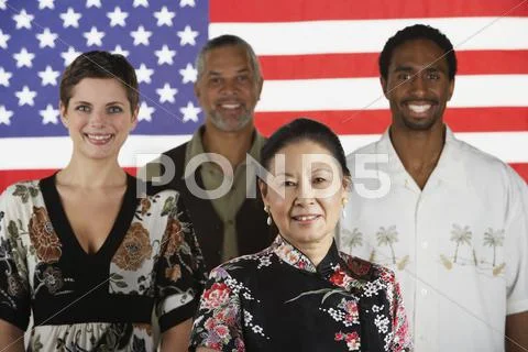 Multi-ethnic people standing in front of american flag Stock Photos