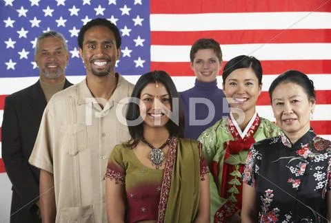 Multi-ethnic people standing in front of American flag Stock Photos