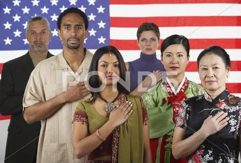 Multi-ethnic people standing in front of American flag Stock Photos