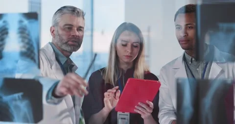 Multi-ethnic positive collaborating people doctors discussing disease and Stock Footage 148560061