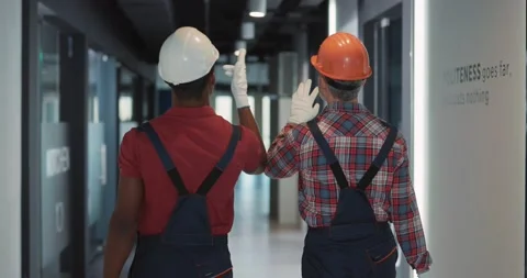 Multi-ethnic repair services couple of electrician and adult engineer walking Stock Footage 149854341