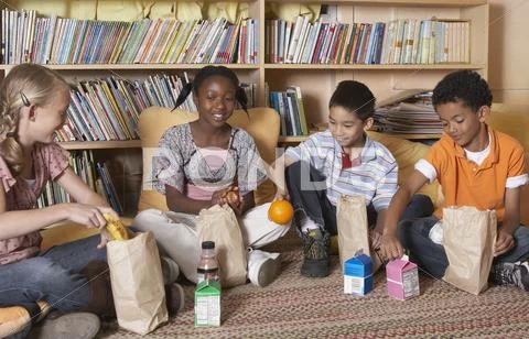 Multi-ethnic school children eating lunch Stock Photos