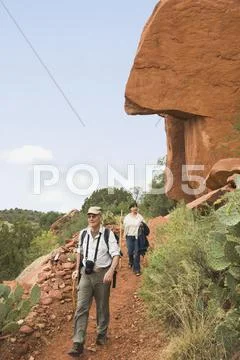 Multi-ethnic senior couple hiking in desert Stock Photos