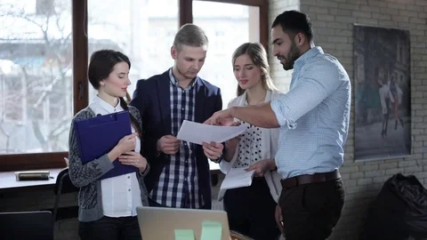 Multi-ethnic startup team is brainstorming and discussing new ideas in office Stock Footage 73181239