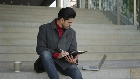 Multi-Ethnic Student Engaged in Laptop Work on University Stairs. A Young Lawyer Stock Footage 243632178