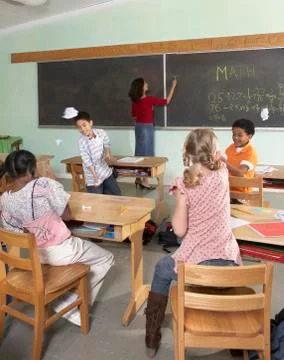 Multi-ethnic students acting up in class Stockfoto's