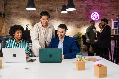 Multi ethnic team collaborating on project in modern office Stock Photos