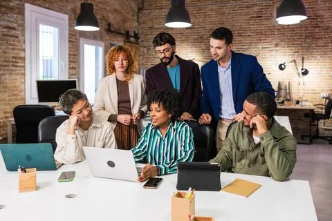 Multi ethnic team collaborating on a project in modern office Stock Photos