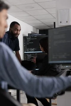 Multi ethnic team of software developers talking about html code Stock Photos