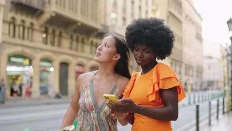 Multi-ethnic tourists searching for a direction using the mobile GPS Stock Footage 255552662