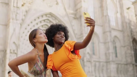 Multi-ethnic tourists taking a selfie in the entrance of a Church Stock Footage 255552799
